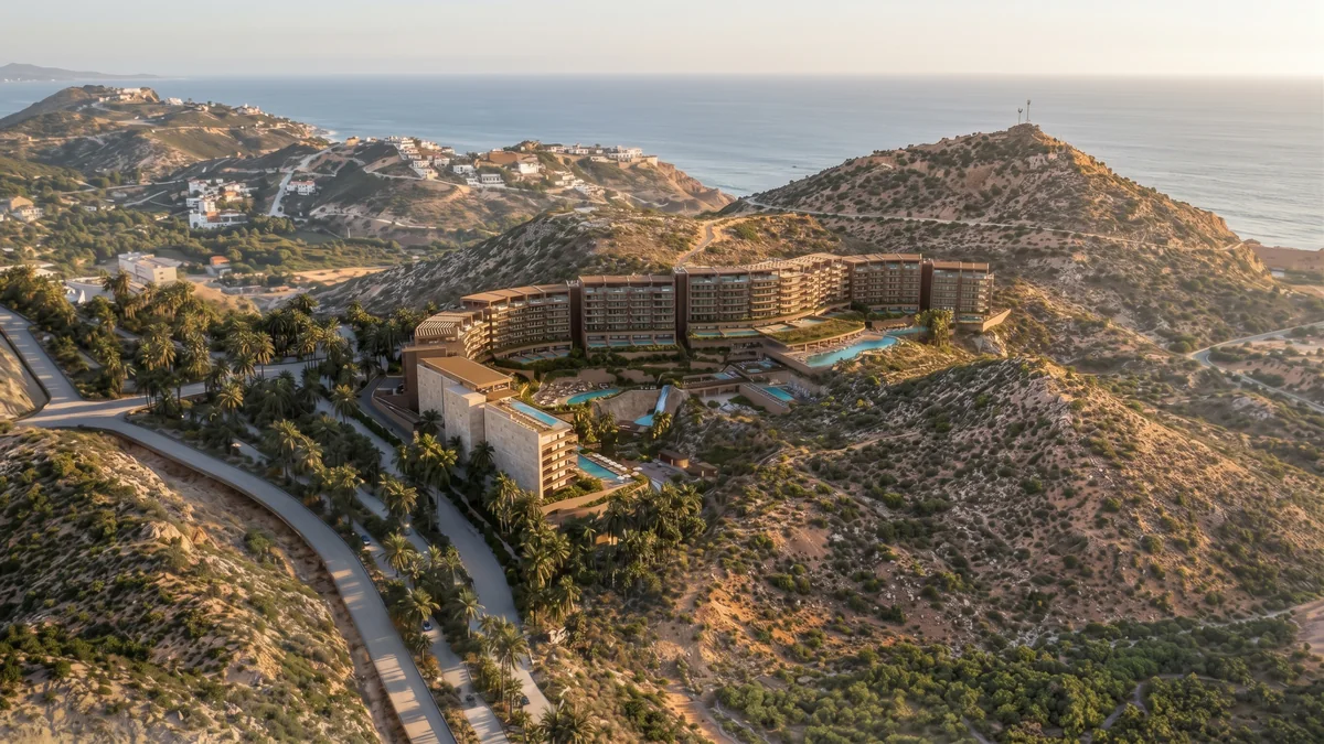 Render of DUNNA’s residences and pools set into the Baja hills, with the ocean beyond